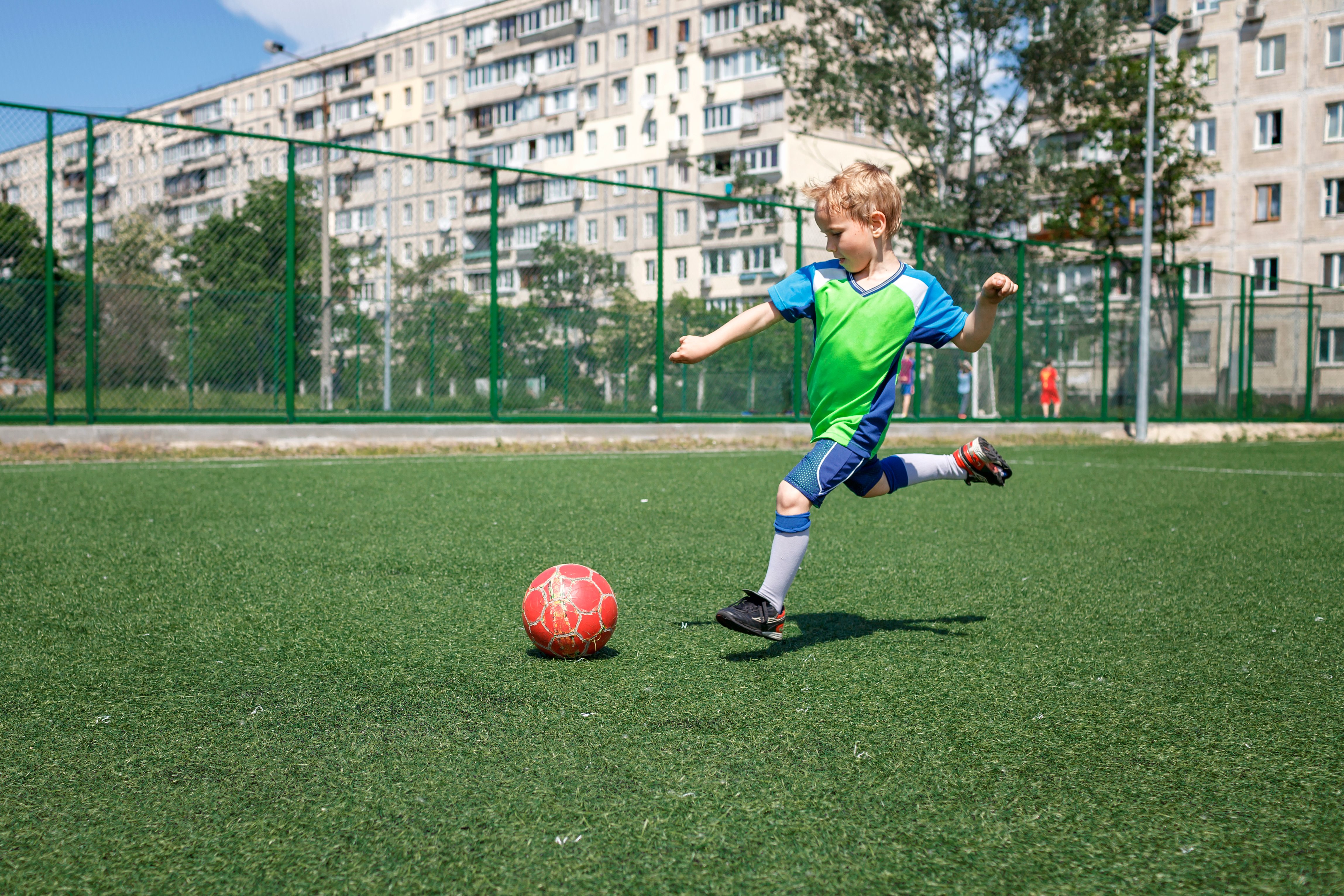 little-boy-in-blue-and-green-form-playing-football-2021-09-03-05-59-22-utc